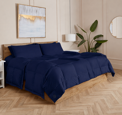 Navy Sleeping Dove cooling comforter set on a bed in a bedroom with wooden flooring and decor.