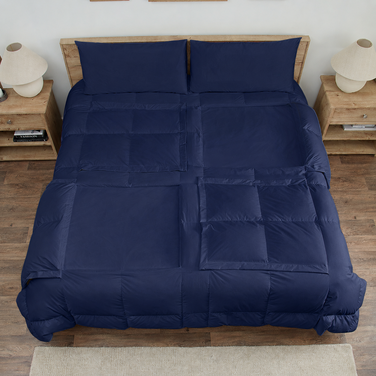 Navy Sleeping Dove cooling comforter set on a bed in a bedroom with wooden flooring and decor.