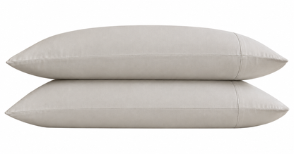 Two stone pillows stacked on a white background