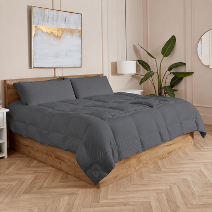 Slate Sleeping Dove cooling comforter set on a bed in a bedroom with wooden flooring and decor.
