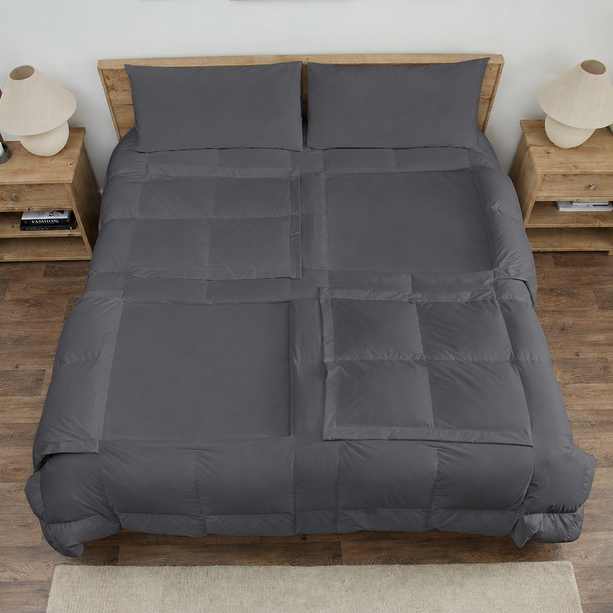 Slate Sleeping Dove cooling comforter set on a bed in a bedroom with wooden flooring and decor.