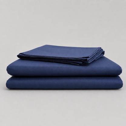 A stack of three folded navy blue sheets or fabric pieces on a light gray studio background.
