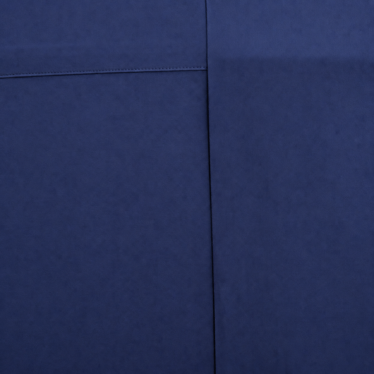 A close-up of a Navy fabric surface with visible texture and a seam dividing the frame into two sections.