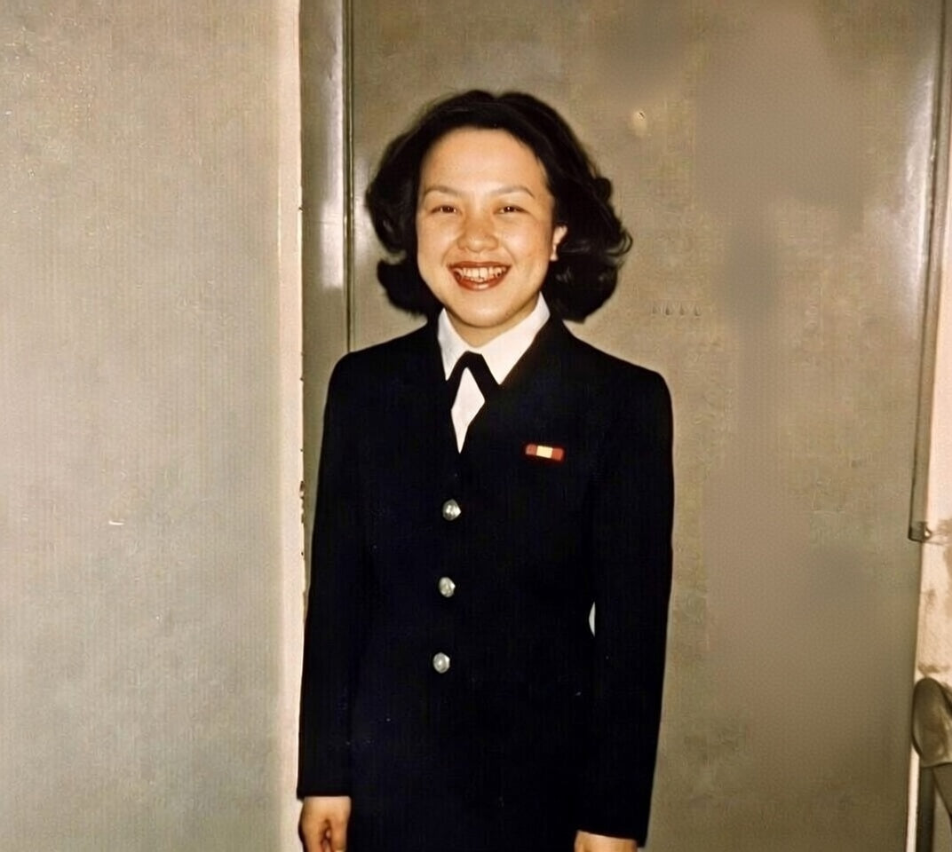 A woman wearing a black US Navy uniform