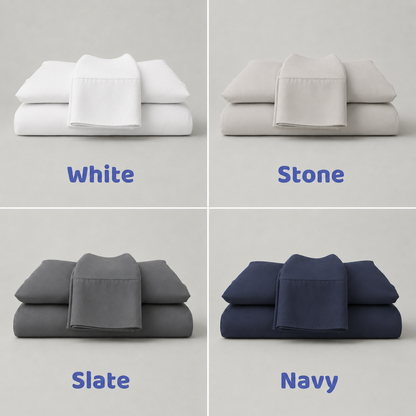 Four stacks of folded bedding in white, stone, slate, and navy on a light gray background.